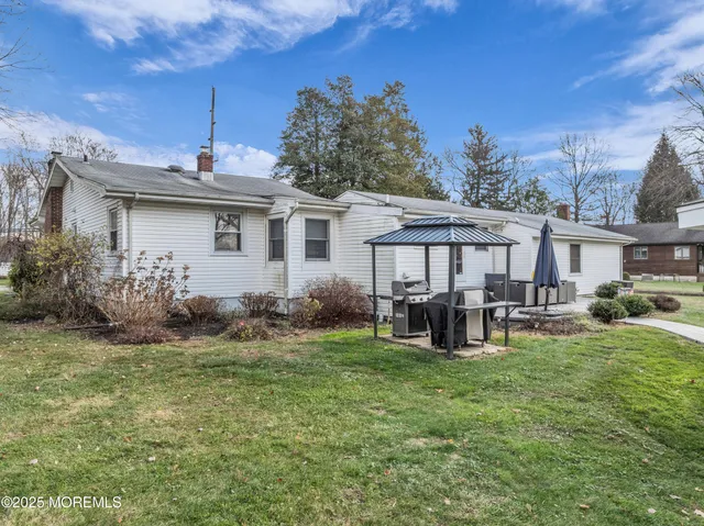a view of a house with backyard sitting area and garden