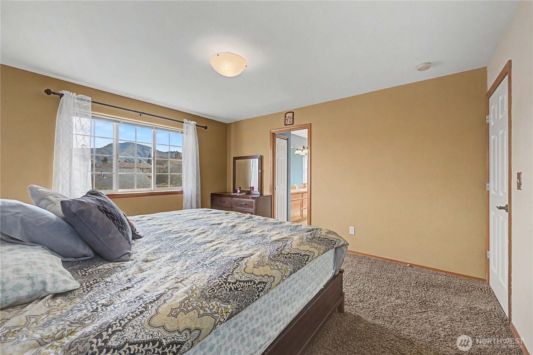1929 Hideaway Place Wenatchee, WA 98801 - Photo 16 of 35 a bedroom with a bed dresser and a large window