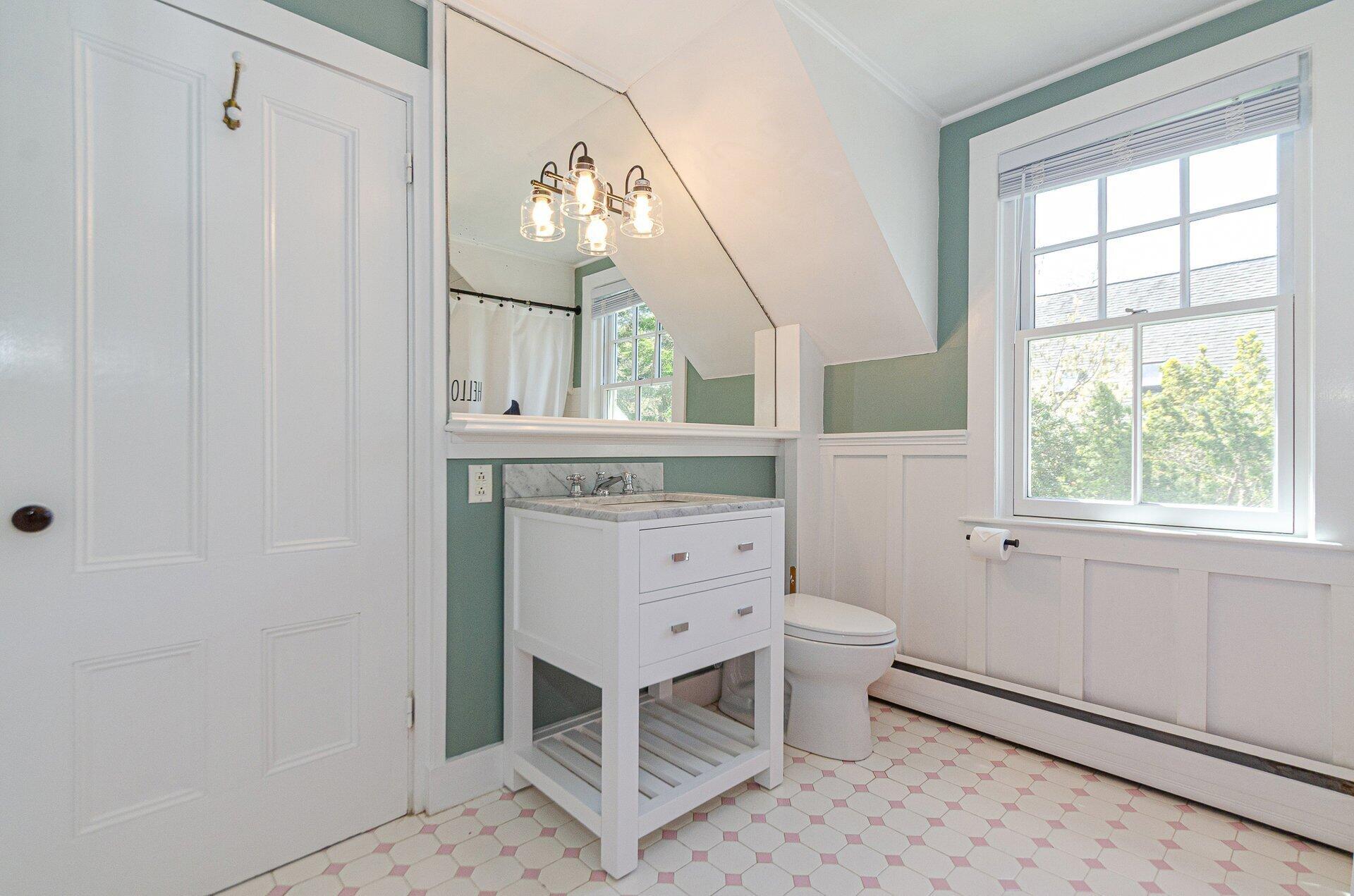 1089 Main Street Cotuit, MA 02635 - Photo 23 of 41 a bathroom with a sink a toilet and a window