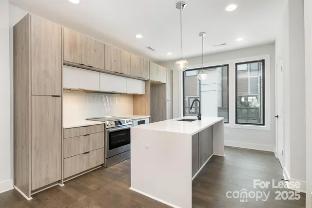 a kitchen with a stove a sink and a refrigerator