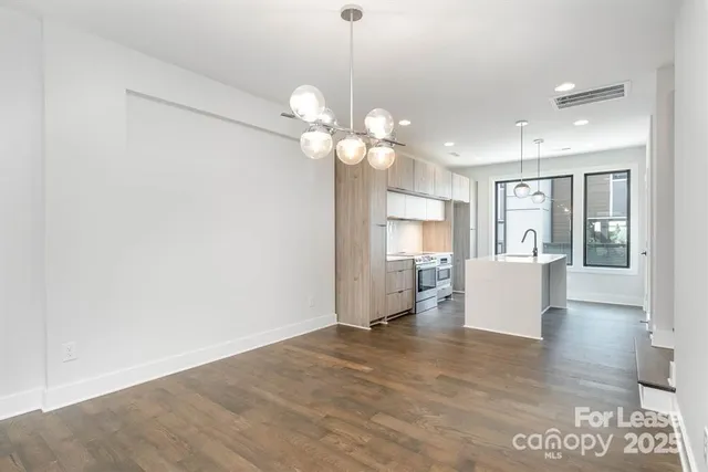 a view of a living room and kitchen with a ceiling fan
