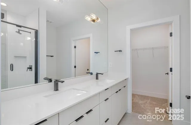a bathroom with a sink double vanity and a mirror