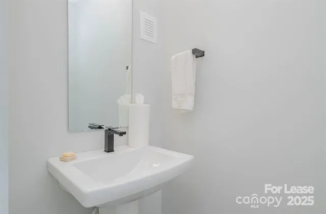 a bathroom with a sink and mirror