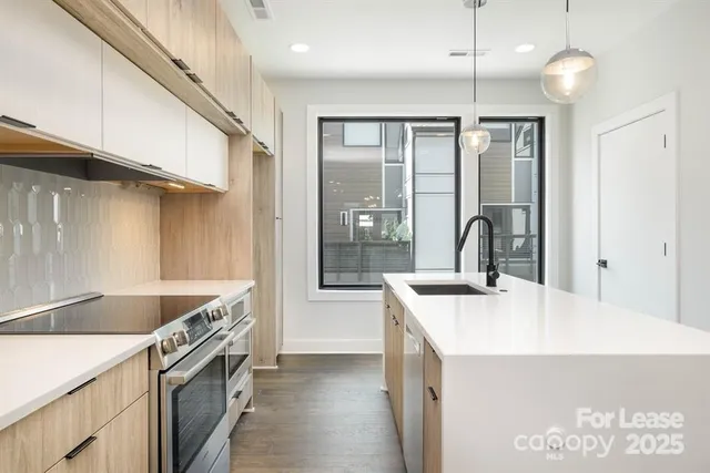 a kitchen with a stove a sink and a refrigerator