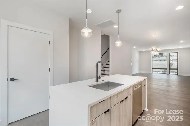 a kitchen with a sink a counter space and a refrigerator