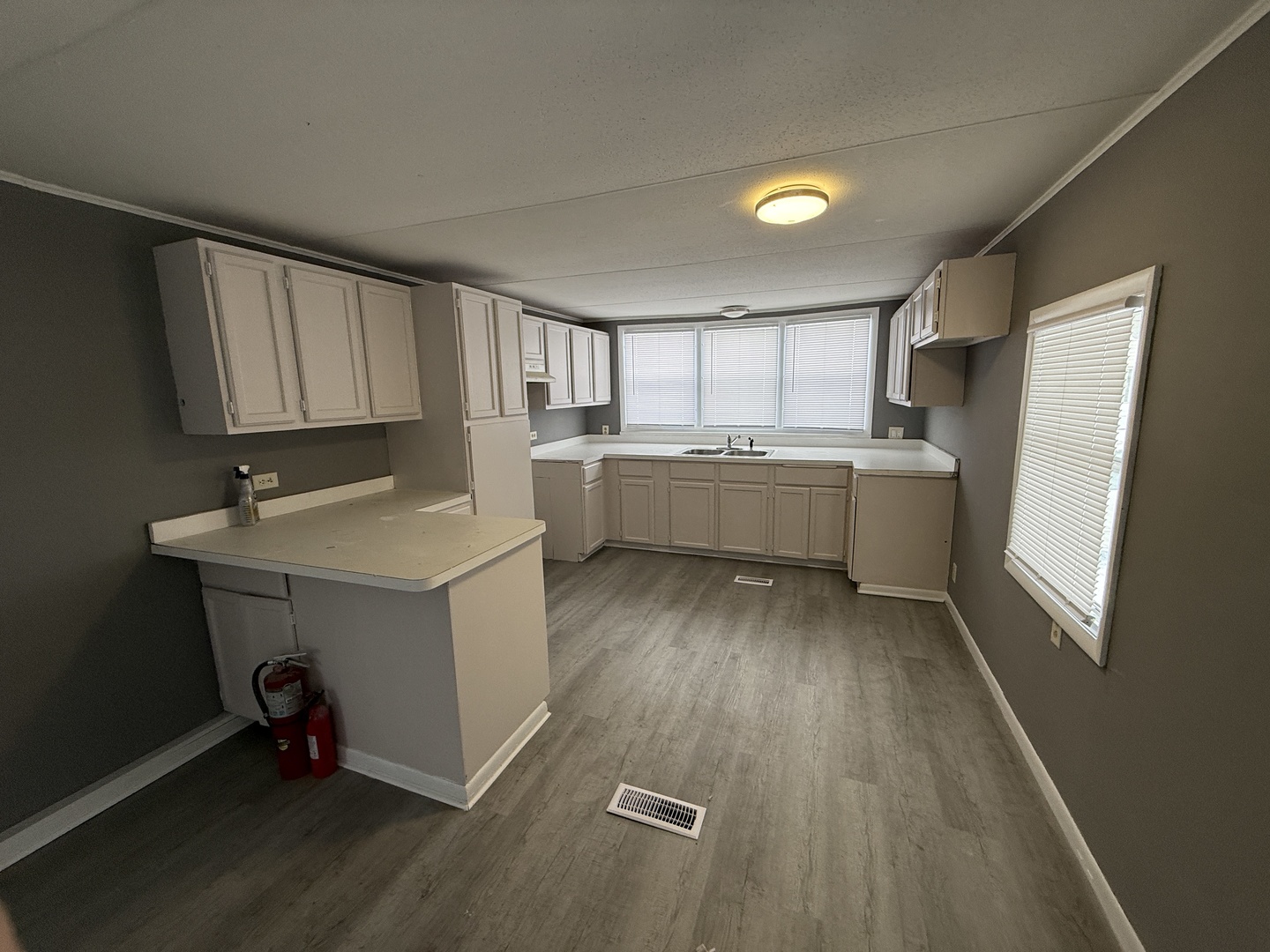 1712 South Dixie Highway, Unit 37 Crete, IL 60417 - Photo 12 of 16 a room with a sink wooden floor and cabinets