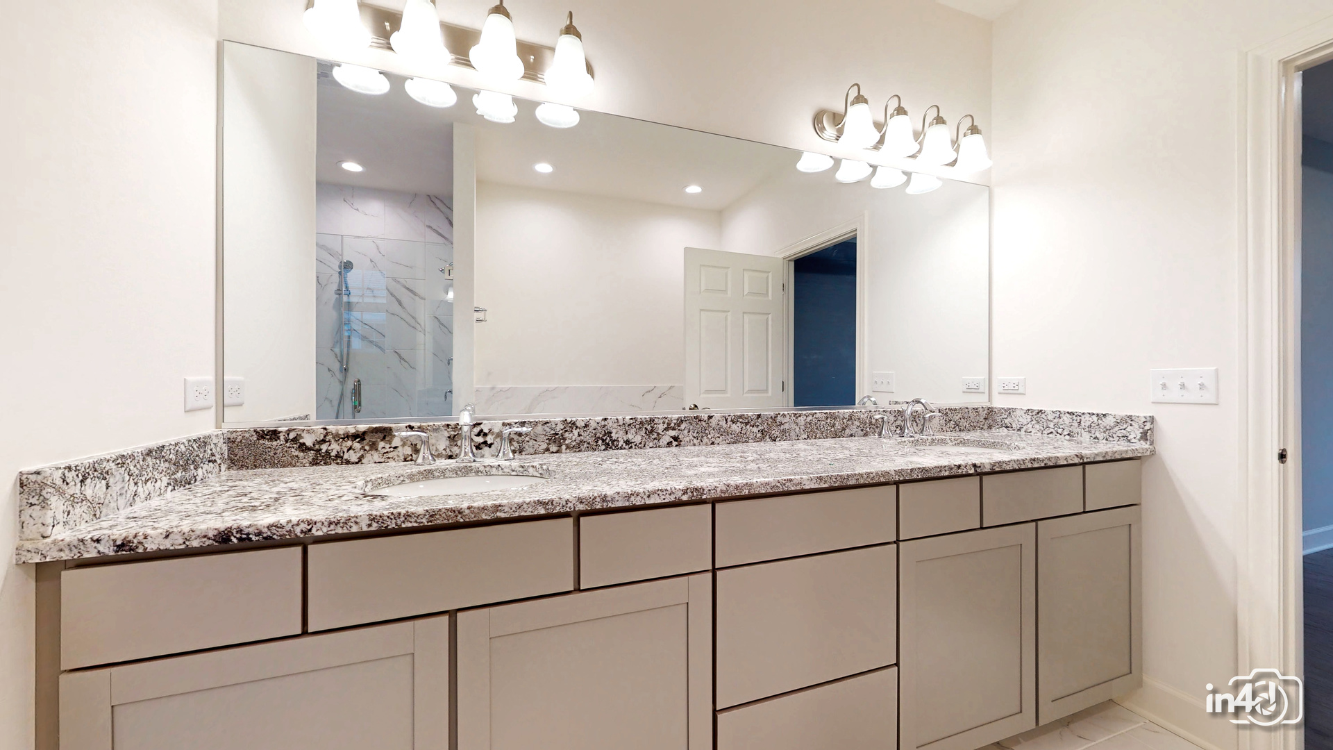 1431 Somerset Place Barrington, IL 60010 - Photo 15 of 28 a bathroom with a granite countertop sink a large mirror and a shower