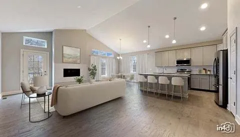 a living room with furniture and a kitchen view