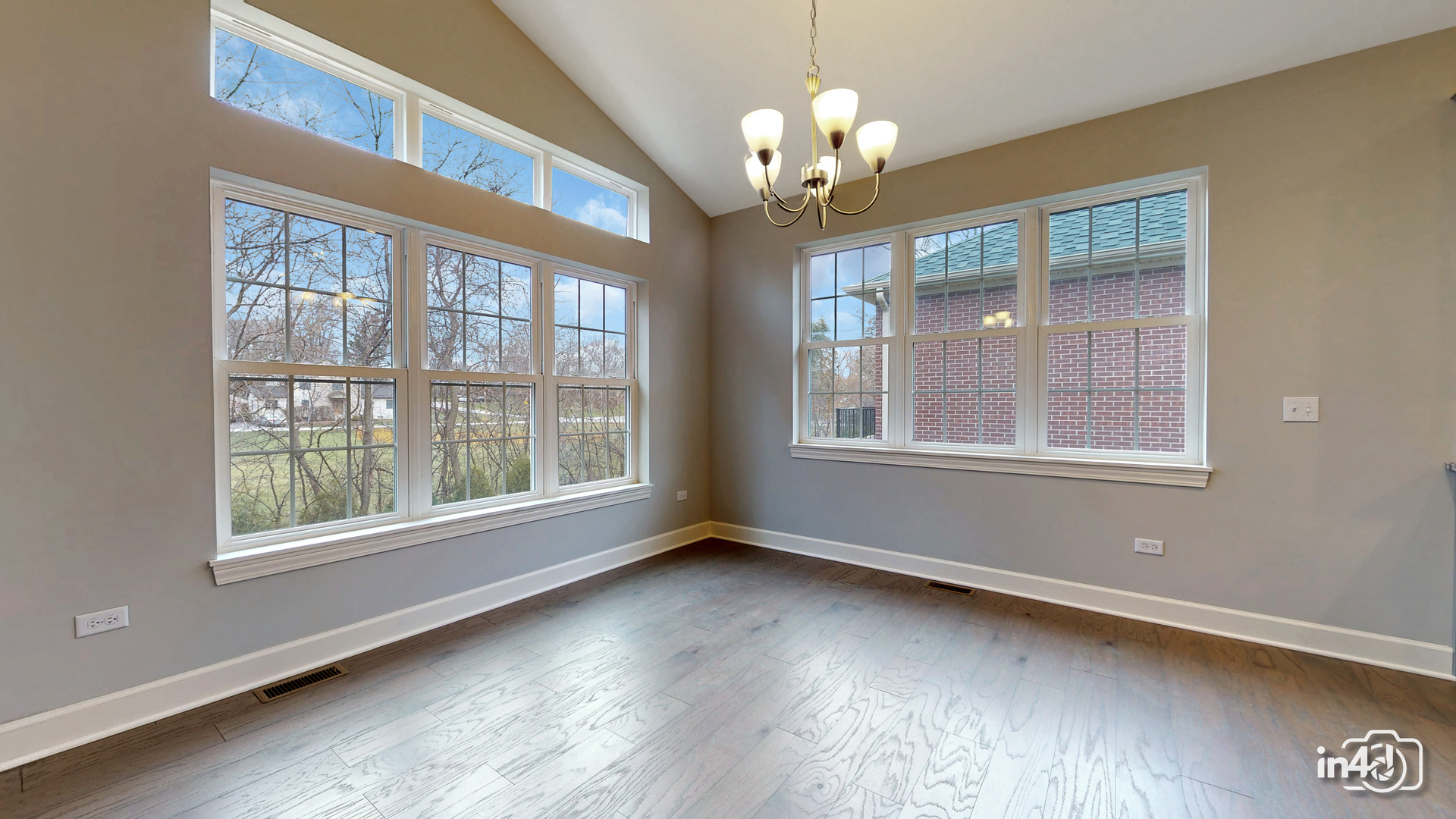 1431 Somerset Place Barrington, IL 60010 - Photo 8 of 28 a view of an empty room with wooden floor and a window