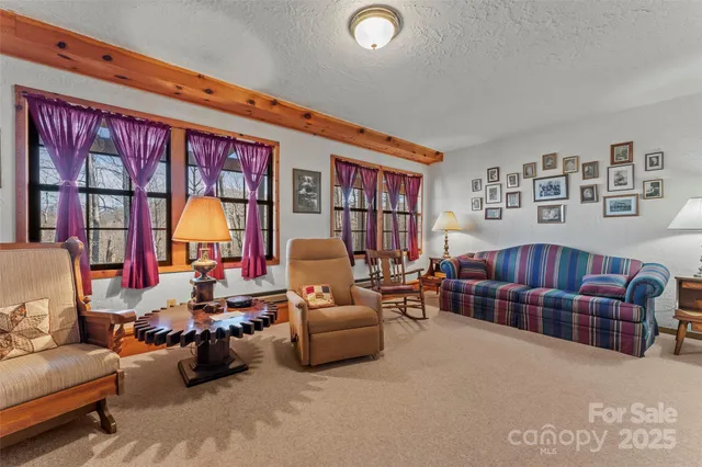 a room with furniture a flat screen tv and a window