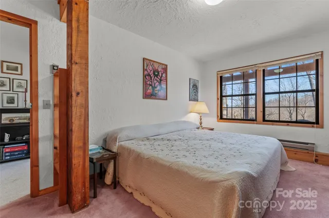 a bed room with a bed and a lamp