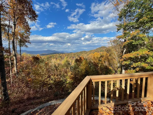 a view of a balcony with wooden fence
