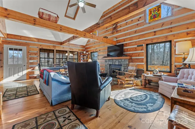 a living room with fireplace furniture and a large window