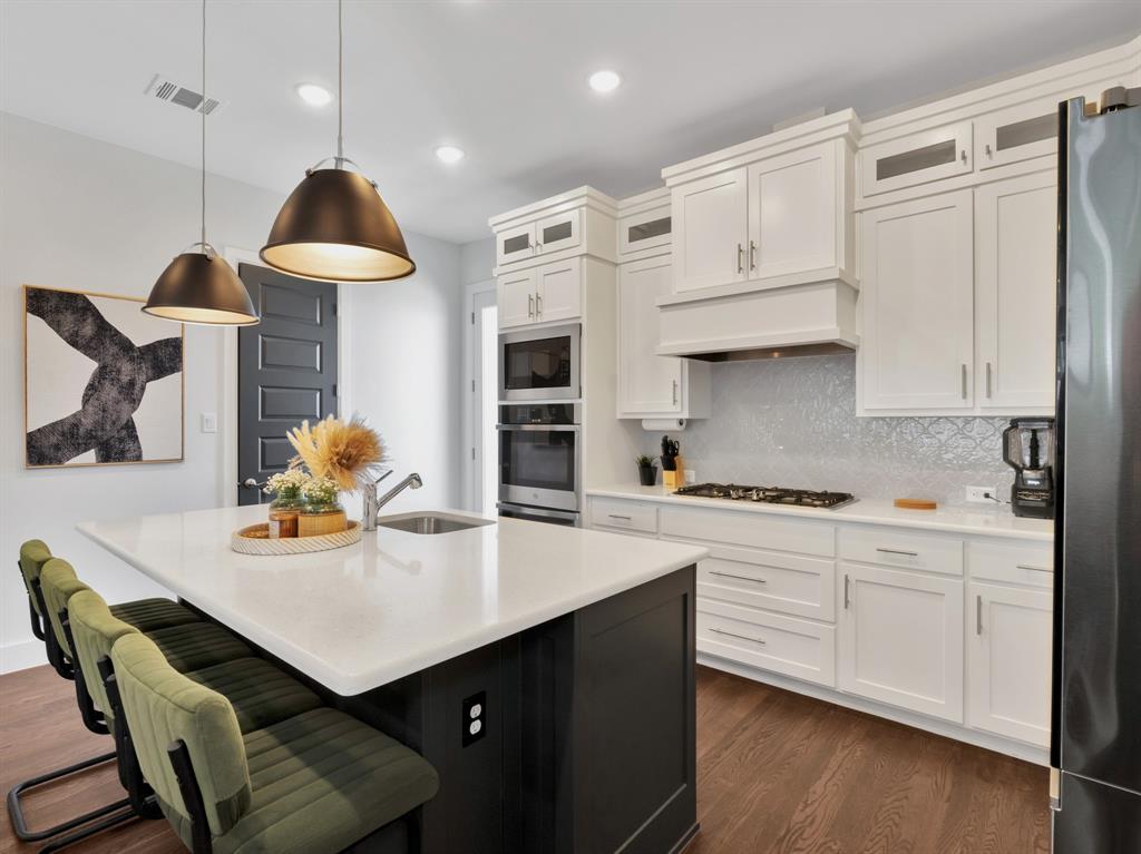 602 Winners Circle Rowlett, TX 75088 - Photo 9 of 28 Kitchen with decorative light fixtures, glass insert cabinets, white cabinets, dark wood finished floors, and recessed lighting