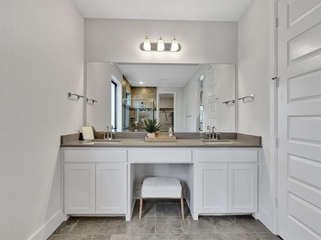 602 Winners Circle Rowlett, TX 75088 - Photo 15 of 28 Full bath with double vanity, a shower stall, and light tile patterned flooring