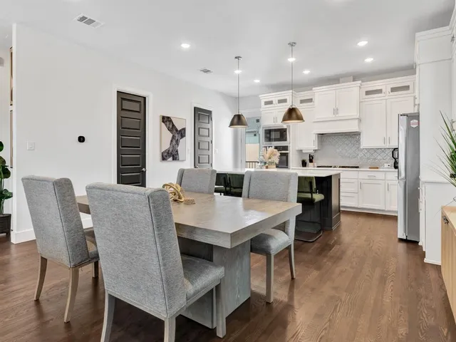 a large kitchen with a table and chairs