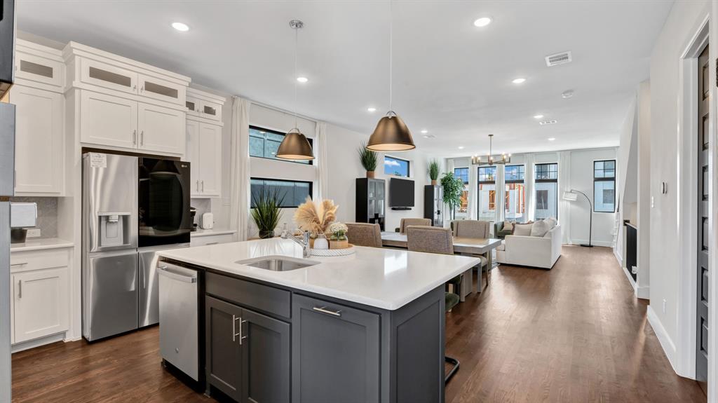 602 Winners Circle Rowlett, TX 75088 - Photo 28 of 28 Kitchen featuring stainless steel appliances, white cabinetry, open floor plan, recessed lighting, and a kitchen island with sink