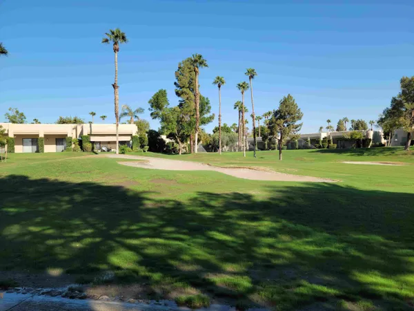 a view of a golf course with a big yard