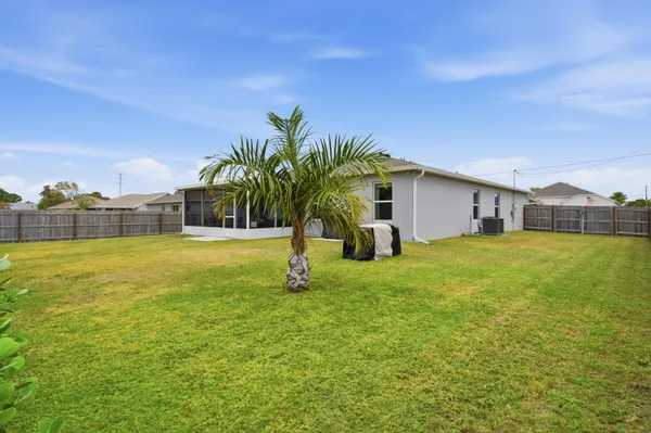 a house view with swimming pool in front of it