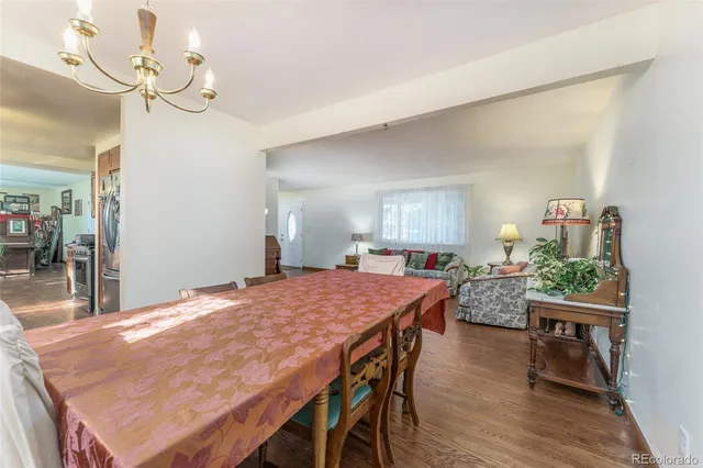 a dining room with a table chairs and wooden floor