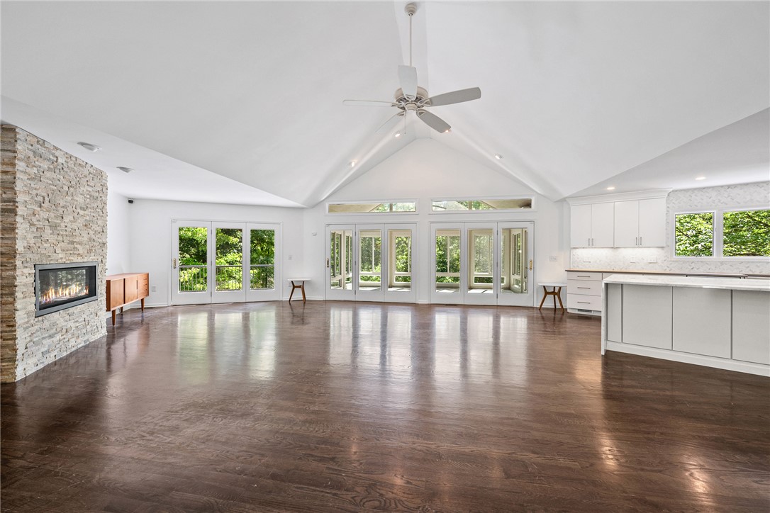 118 Beacon Ridge Circle Salem, SC 29676 - Photo 3 of 45 A spacious, airy great room features hardwood floors, a stone fireplace, and French doors opening to outdoor living.