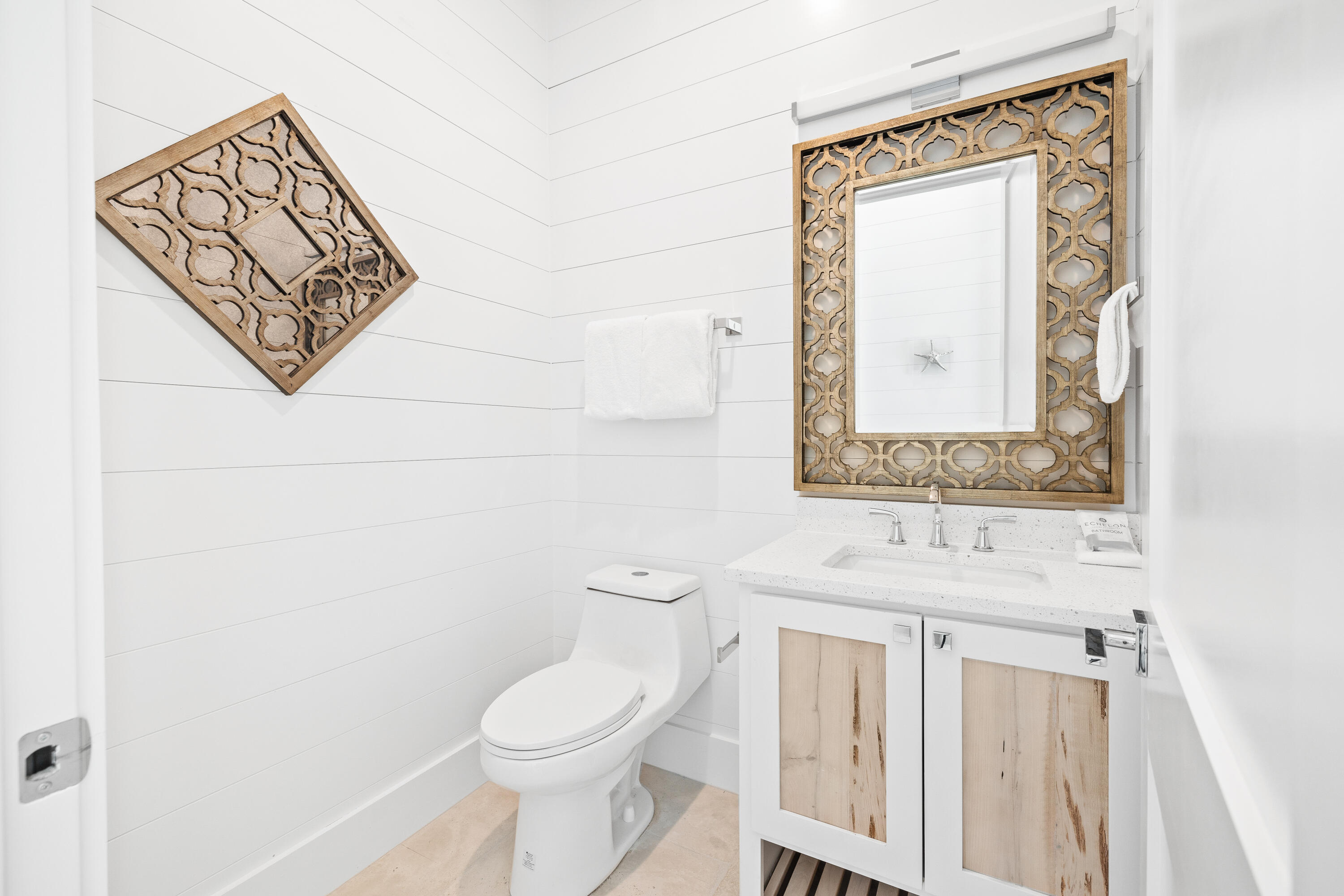 196 South Wall Street Inlet Beach, FL 32461 - Photo 26 of 85 a bathroom with a toilet sink vanity and mirror