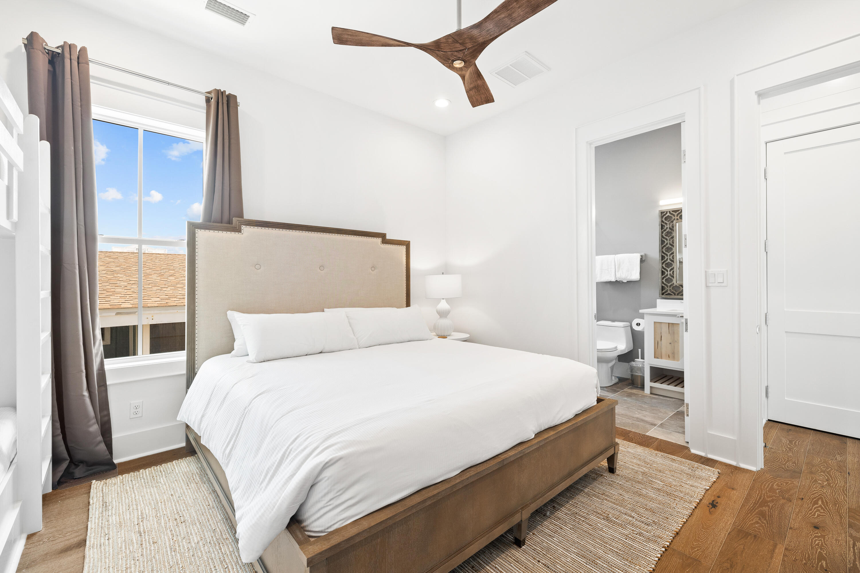 196 South Wall Street Inlet Beach, FL 32461 - Photo 53 of 85 a bedroom with a large bed and a chandelier