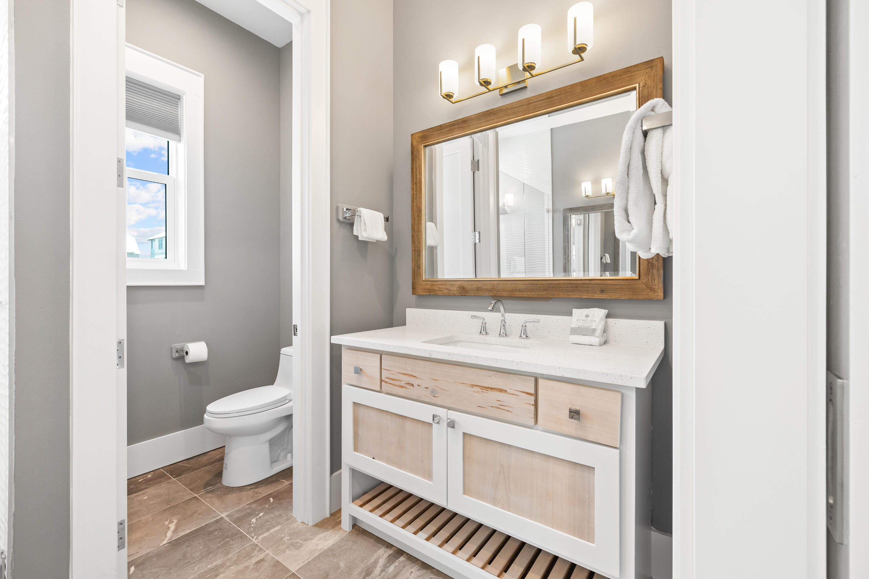 196 South Wall Street Inlet Beach, FL 32461 - Photo 61 of 85 a bathroom with a sink a toilet and a mirror