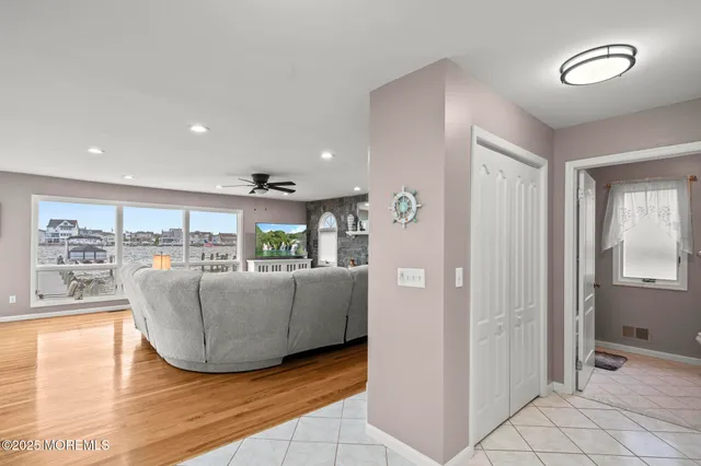 a dining room with furniture and a floor to ceiling window