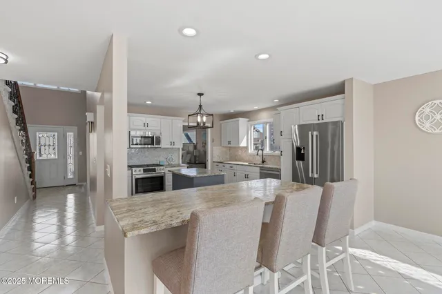 a kitchen with stainless steel appliances granite countertop a sink and stove
