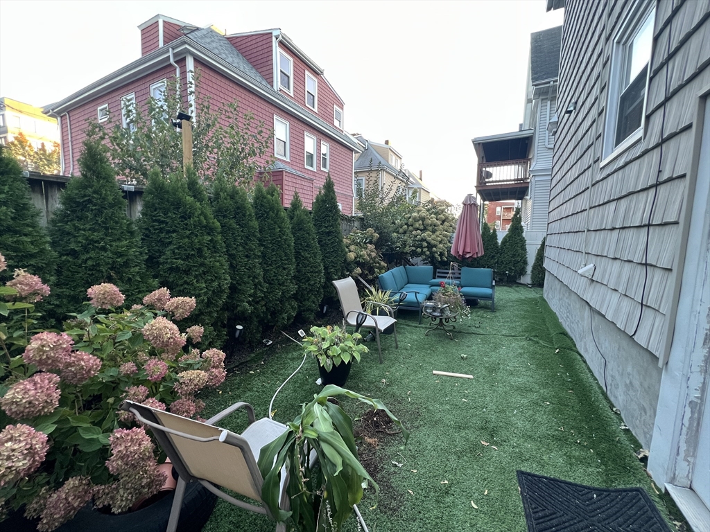 18 Sherman Street, Unit 1 Everett, MA 02149 - Photo 11 of 11 a backyard of a house with lots of green space