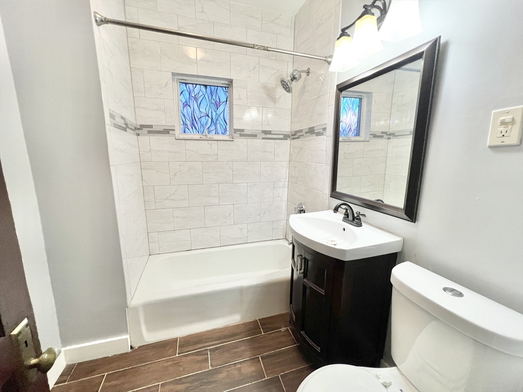 18 Sherman Street, Unit 1 Everett, MA 02149 - Photo 10 of 11 a bathroom with a sink toilet and shower