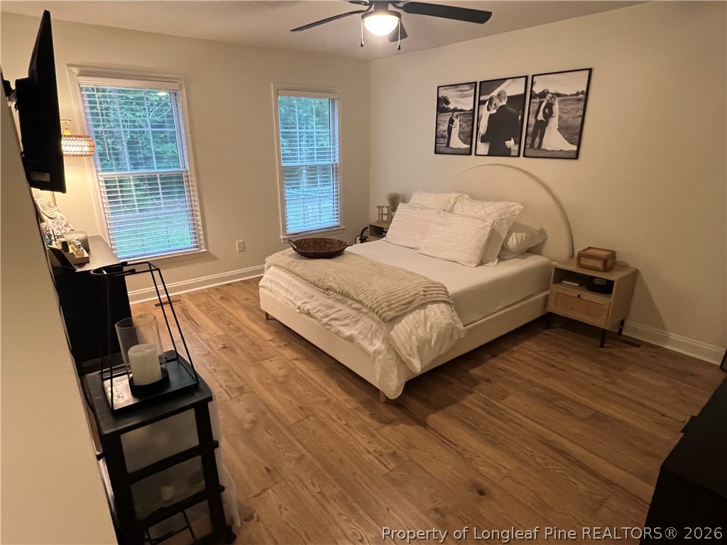 169 Bradshaw Road Bladenboro, NC 28320 - Photo 14 of 34 a bedroom with a bed and wooden floor