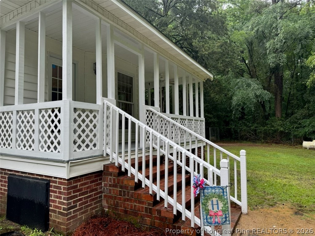 169 Bradshaw Road Bladenboro, NC 28320 - Photo 31 of 34 a view of wooden house with a wooden deck