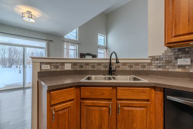 a view of a sink a mirror and cabinets