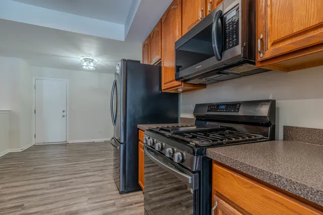 a kitchen with stainless steel appliances granite countertop a stove and a microwave
