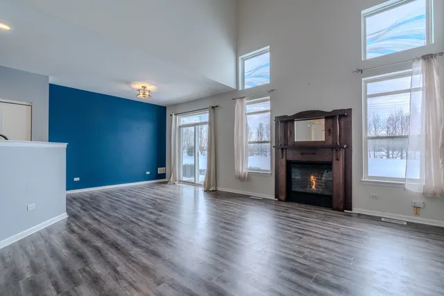 a view of an empty room with window and fire place