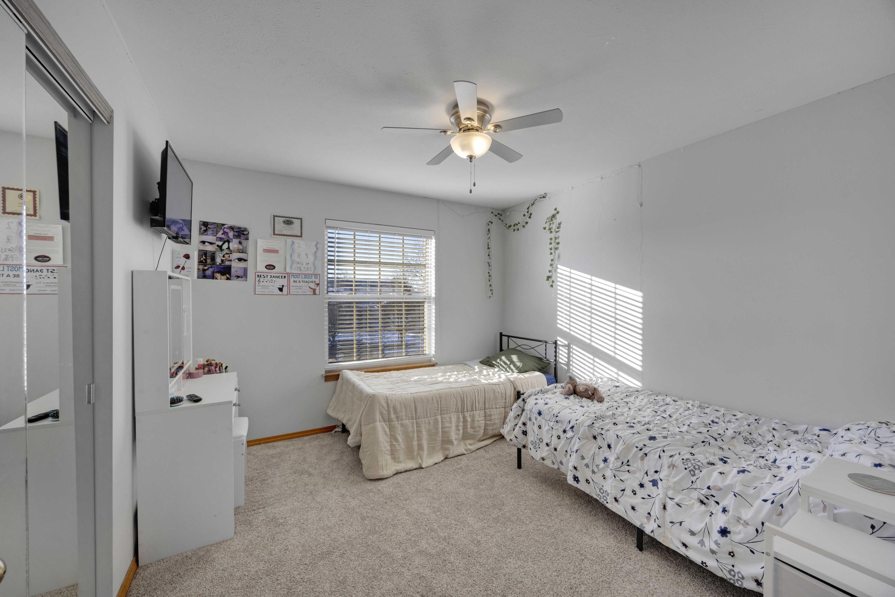 822 Seminole Drive Lowell, IN 46356 - Photo 14 of 28 a bedroom with a bed and a chandelier