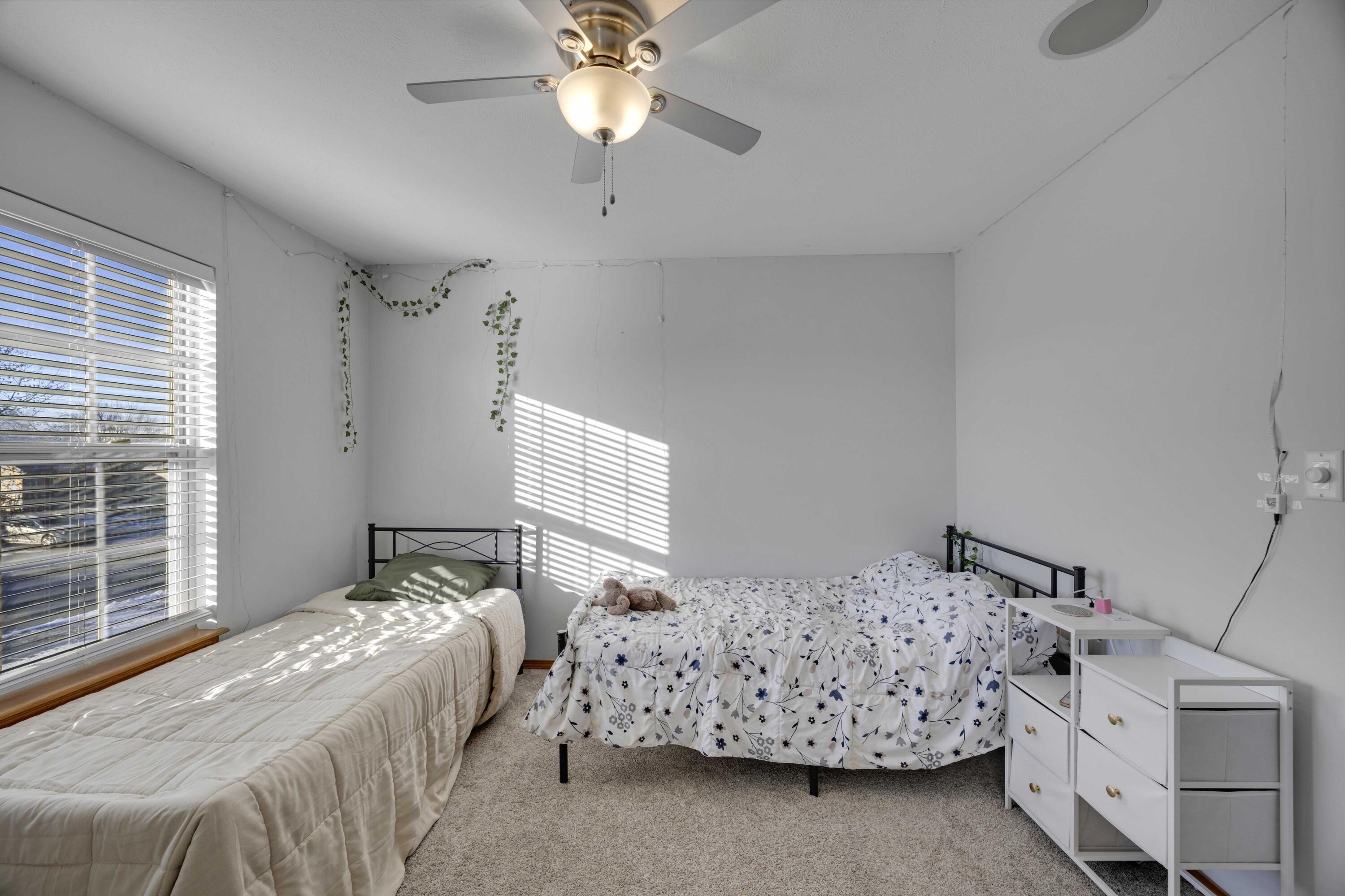 822 Seminole Drive Lowell, IN 46356 - Photo 15 of 28 a bedroom with a bed and a chandelier