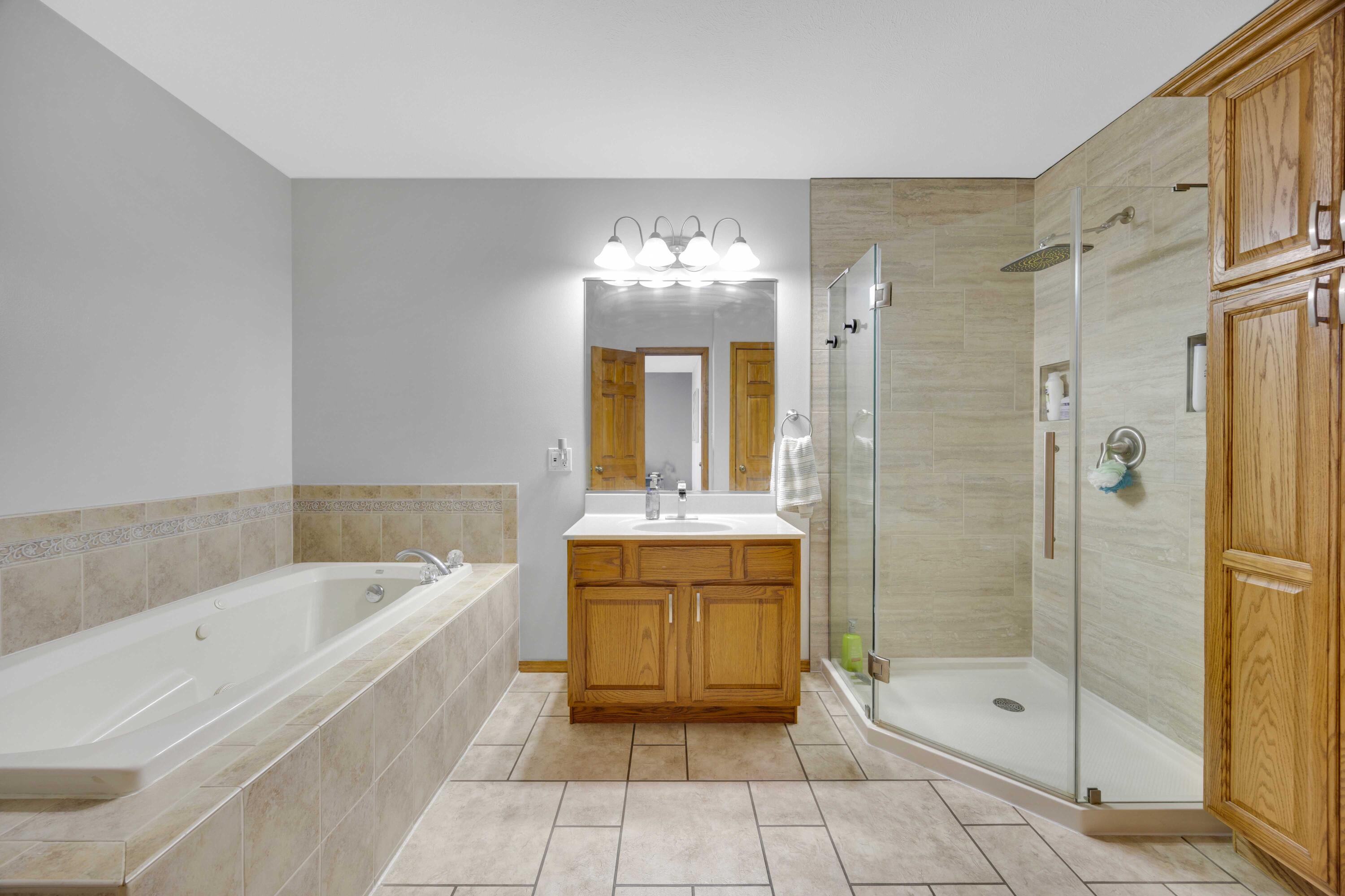 822 Seminole Drive Lowell, IN 46356 - Photo 20 of 28 a large spacious bathroom with a granite countertop tub shower and mirror