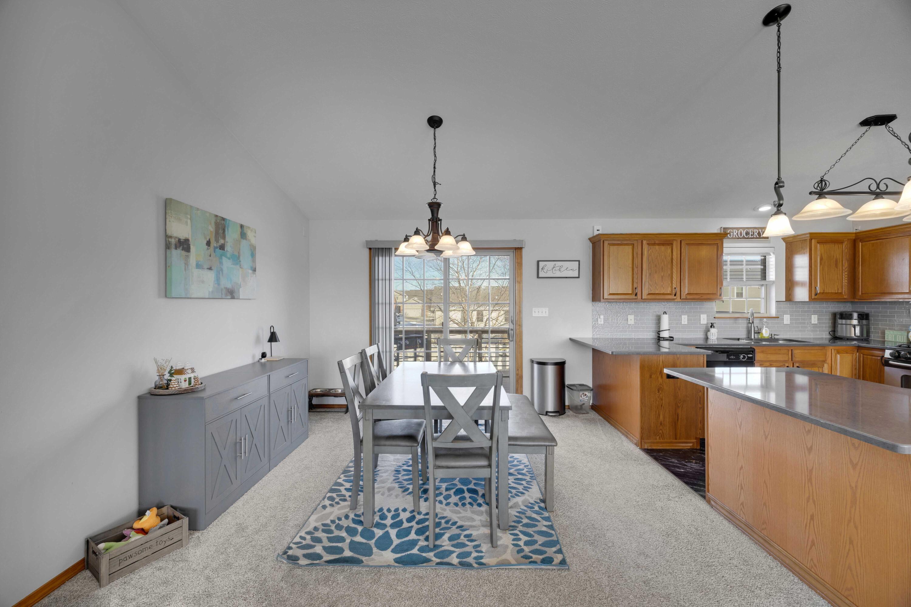 822 Seminole Drive Lowell, IN 46356 - Photo 24 of 28 a living room with furniture a dining table and a stove with wooden floor