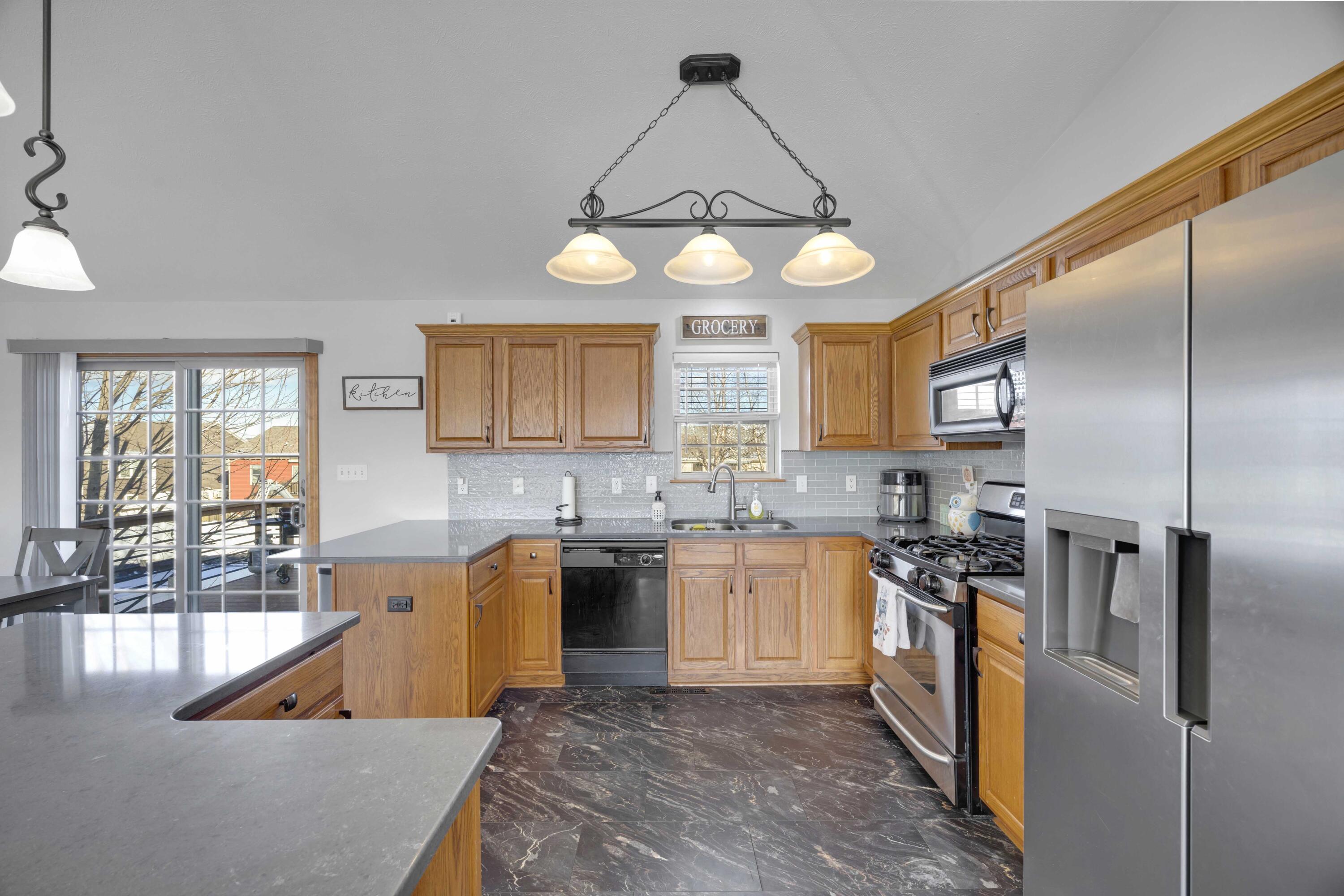 822 Seminole Drive Lowell, IN 46356 - Photo 25 of 28 a kitchen with stainless steel appliances granite countertop a sink a stove and a refrigerator