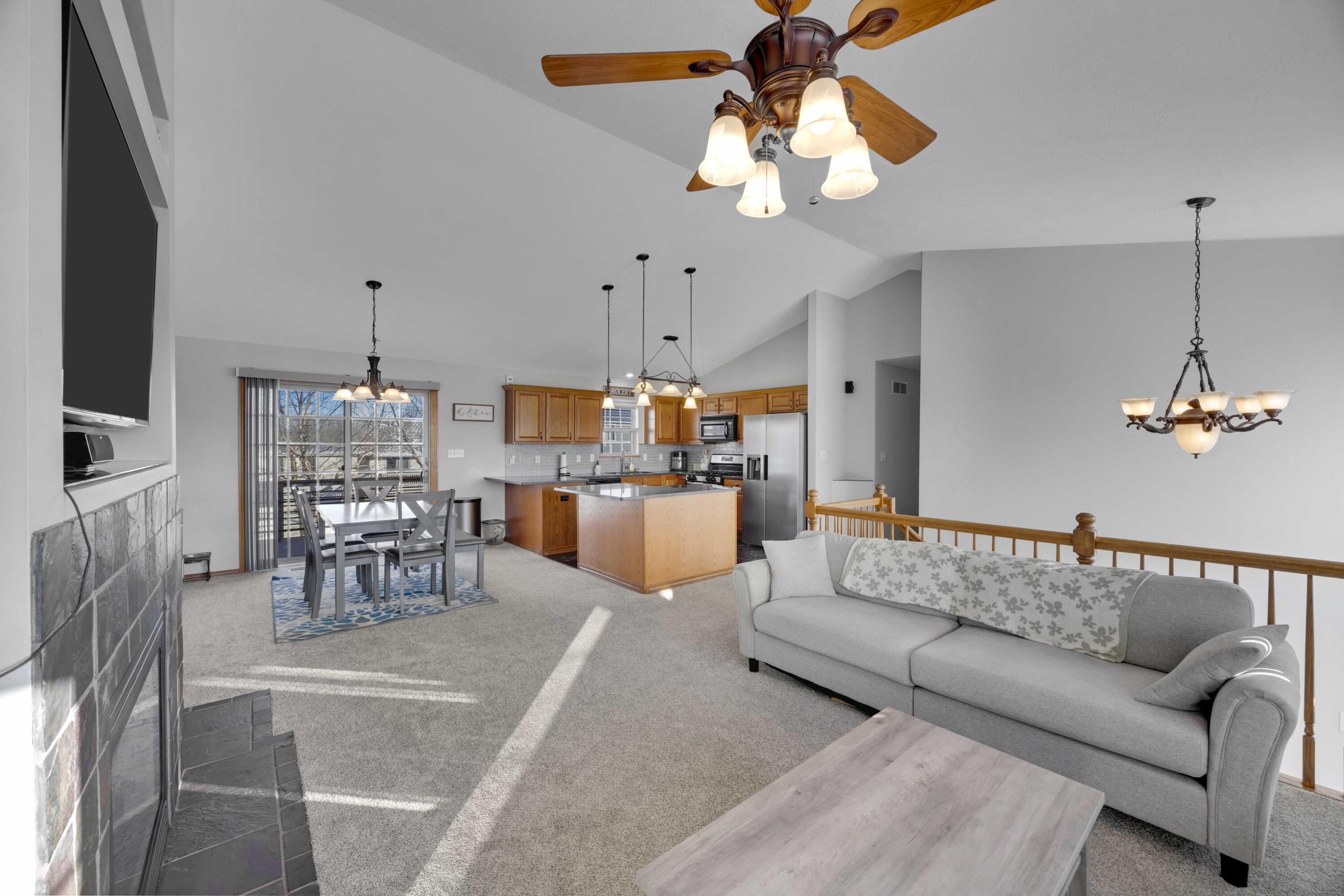 822 Seminole Drive Lowell, IN 46356 - Photo 27 of 28 a living room with furniture kitchen view and a chandelier