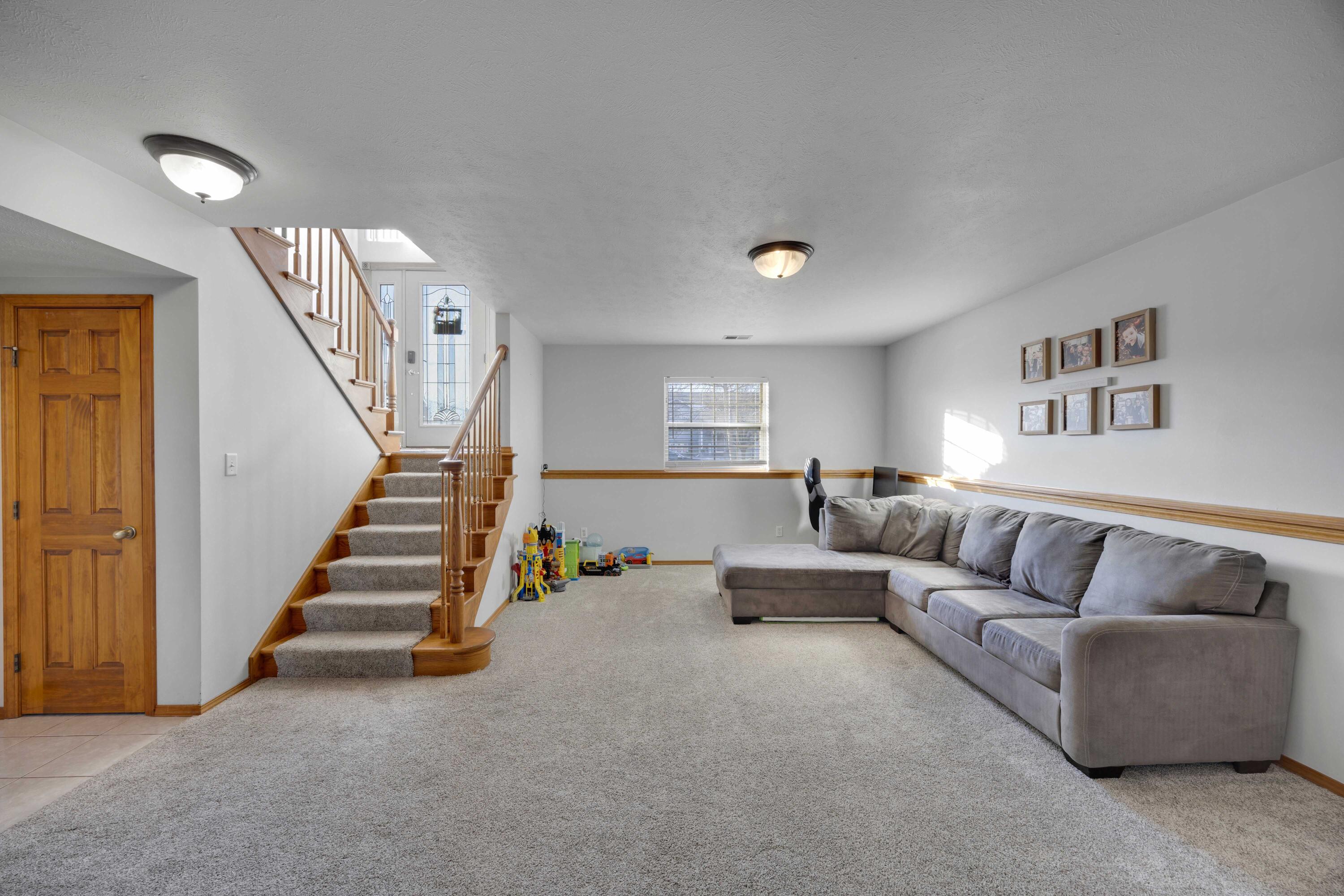 822 Seminole Drive Lowell, IN 46356 - Photo 9 of 28 a living room with furniture and stairs