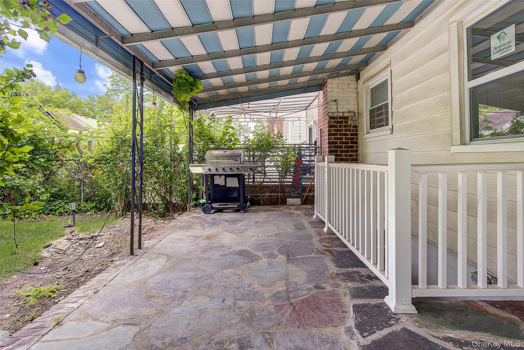 164-38 76th Road Queens, NY 11366 - Photo 42 of 44 a view of a porch with furniture and a yard