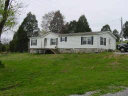 548 Rome Road Riddleton, TN 37151 - Photo 1 of 20 a front view of a house with a garden