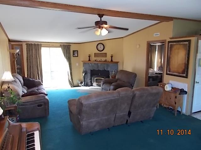 548 Rome Road Riddleton, TN 37151 - Photo 12 of 20 a living room with furniture a fireplace and a flat screen tv