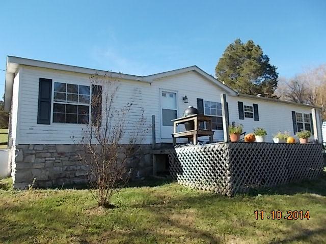548 Rome Road Riddleton, TN 37151 - Photo 6 of 20 a front view of a house with a garden