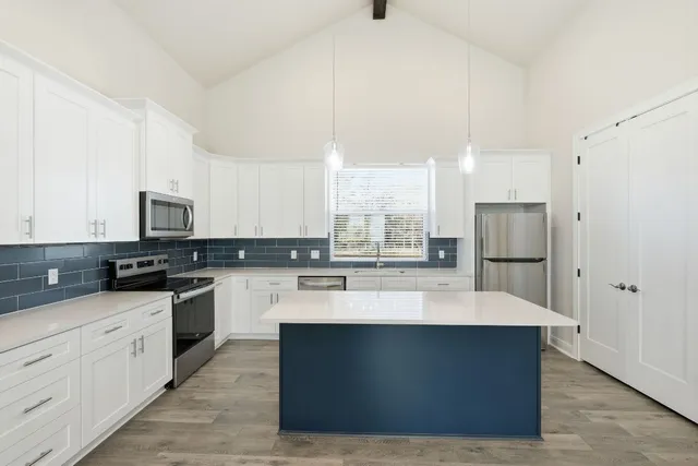 a large kitchen with white cabinets
