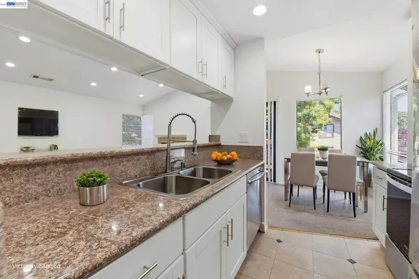 a stove top oven sitting inside of a kitchen
